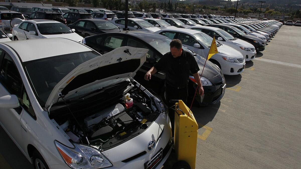 A Toyota shop foreman recharges a Prius parked in Puente Hills, Calif. on Nov. 14, 2012.