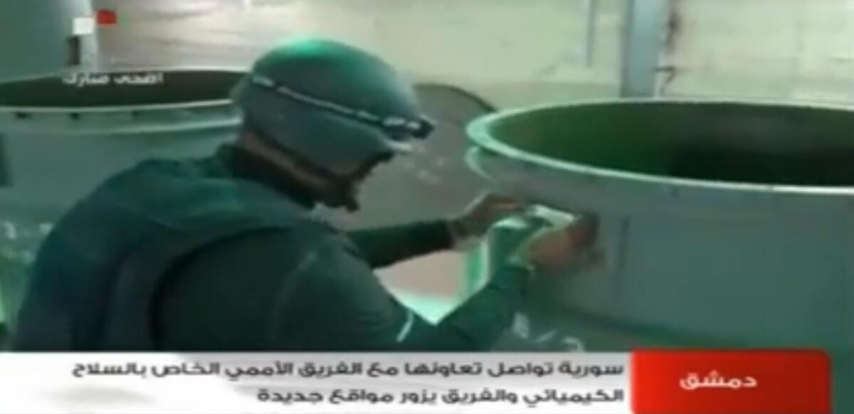 An image grab taken from Syrian television on Oct. 19 shows an inspector from the Organization for the Prohibition of Chemical Weapons (OPCW) at work at an undisclosed location in Syria.