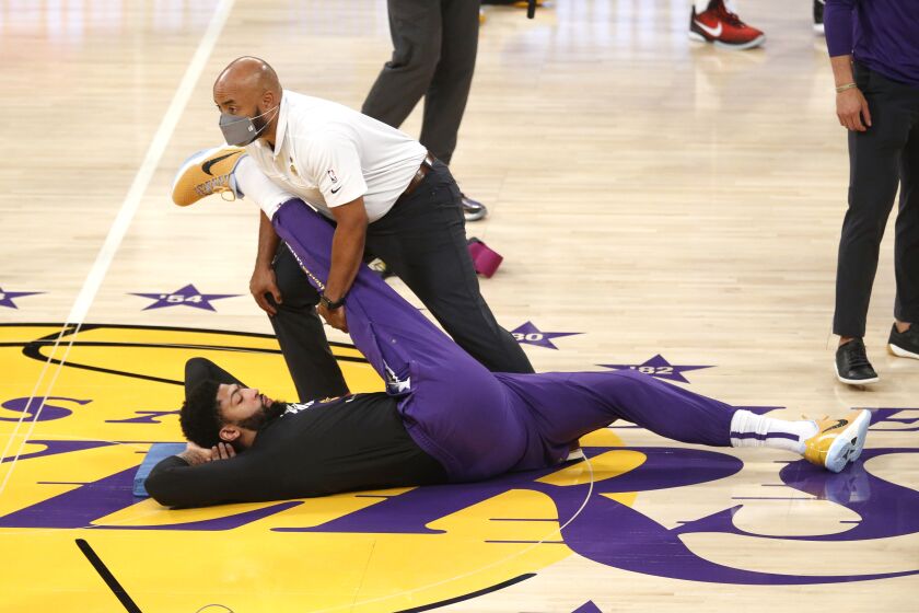 LOS ANGELES, CA - MAY 30: Los Angeles Lakers forward Anthony Davis (3) gets stretched out before the start of a play-off game against the Phoenix Suns at the Staples Center on Sunday, May 30, 2021 in Los Angeles, CA. Game four of the NBA Western Conference first-round playoff series. (Gary Coronado / Los Angeles Times)