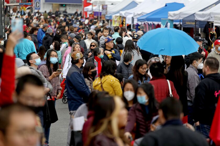 ALHAMBRA, CA - JANUARY 29: Crowds at the Alhambra Lunar New Year Festival along the 200 block of Main St. in downtown on Sunday, Jan. 29, 2023 in Alhambra, CA. Year of the Rabbit. The festival, since 1993, will feature all-day entertainment with lion dancers, live candy sculpting, live Chinese demonstrations, food, merchants abd activity booths, in the heart of Downtown Alhambra. (Gary Coronado / Los Angeles Times)