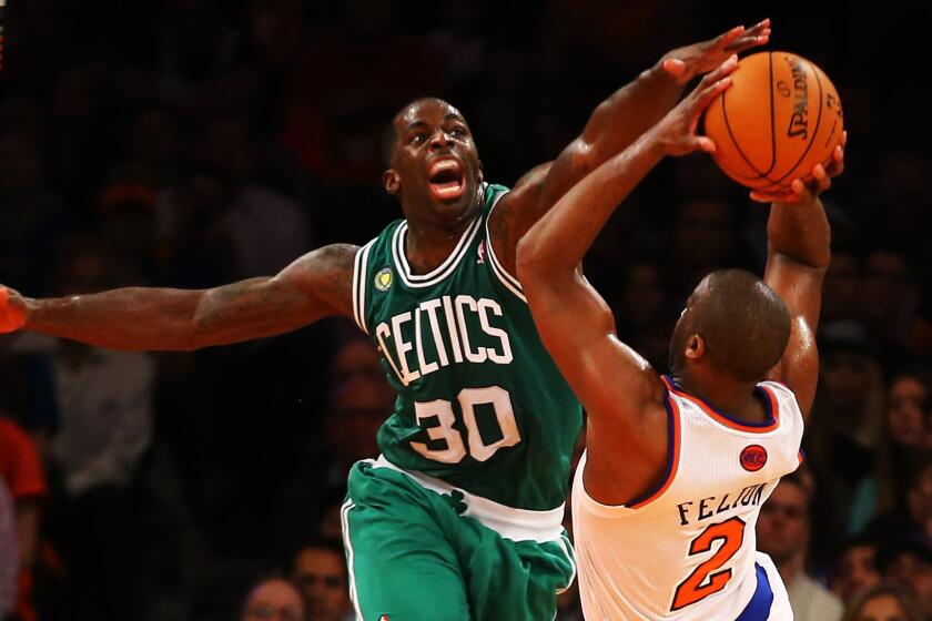 Boston Celtics power forward Brandon Bass, left, tries to block a shot by New York Knicks point guard Raymond Felton during a playoff game in May 2013.