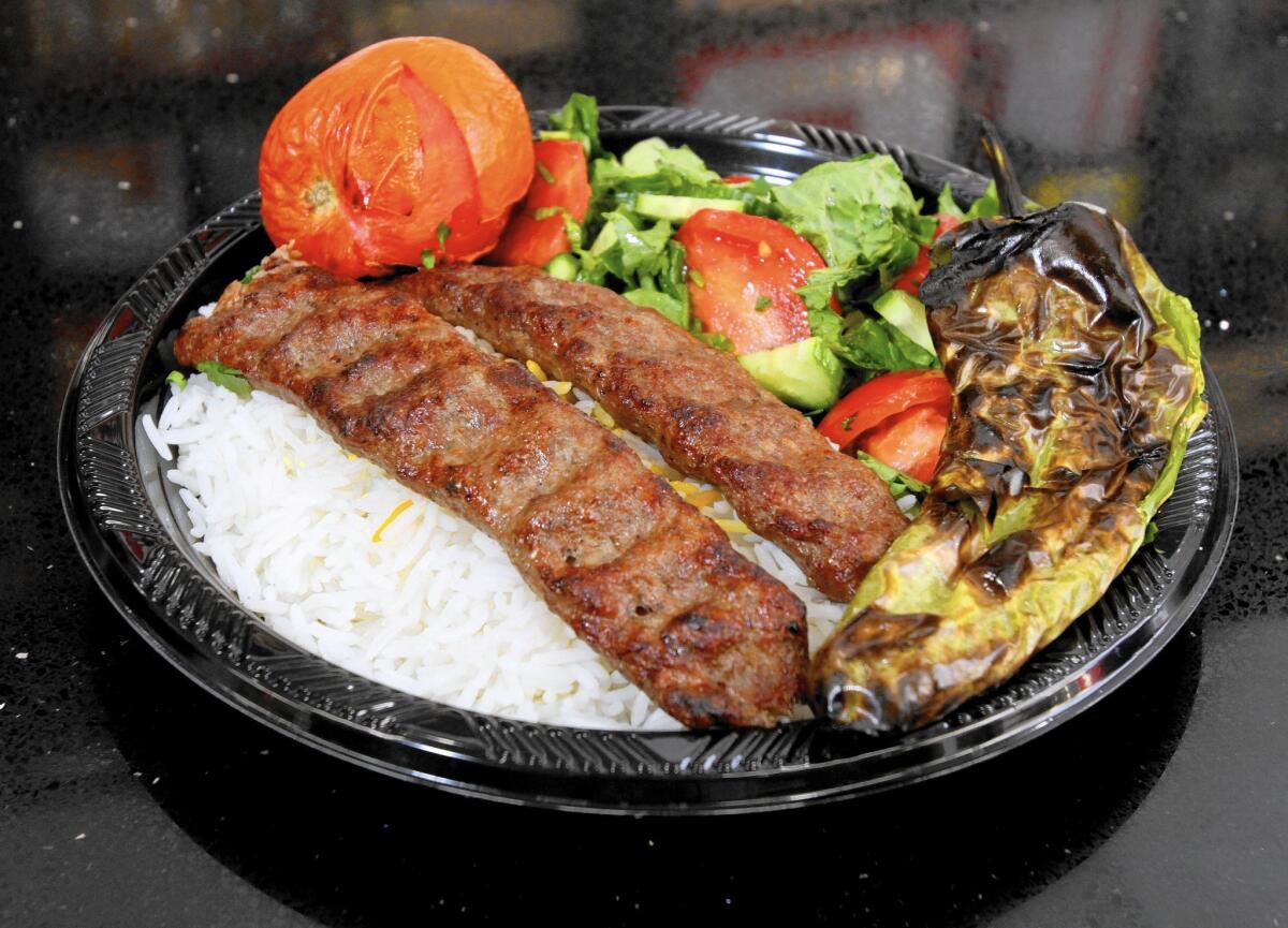 The Lule beef kabob plate comes with rice and salad, one of the prepared foods at NOVA Market & Catering.