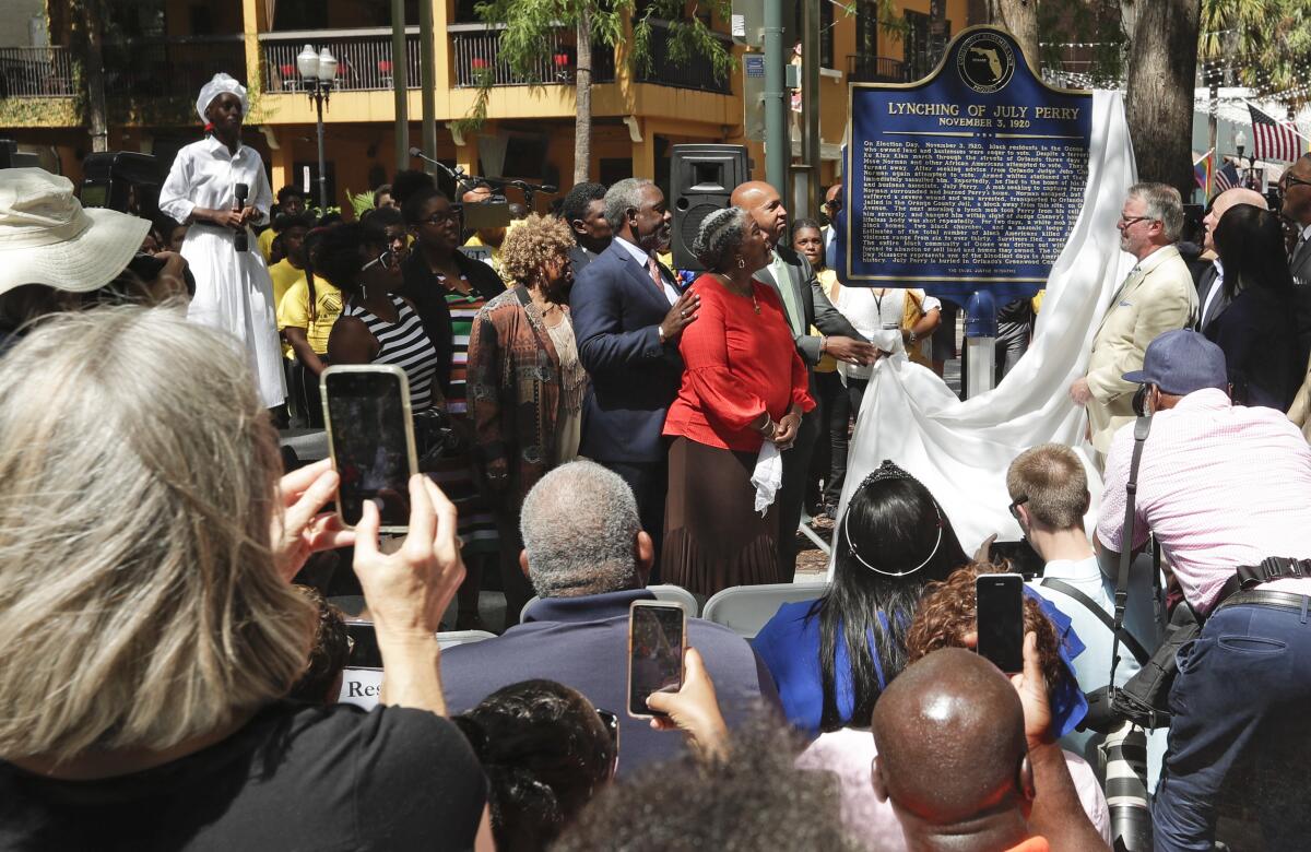 Descendants of July Perry attend a ceremony unveiling a historical marker in Orlando, Fla., in June 2019.