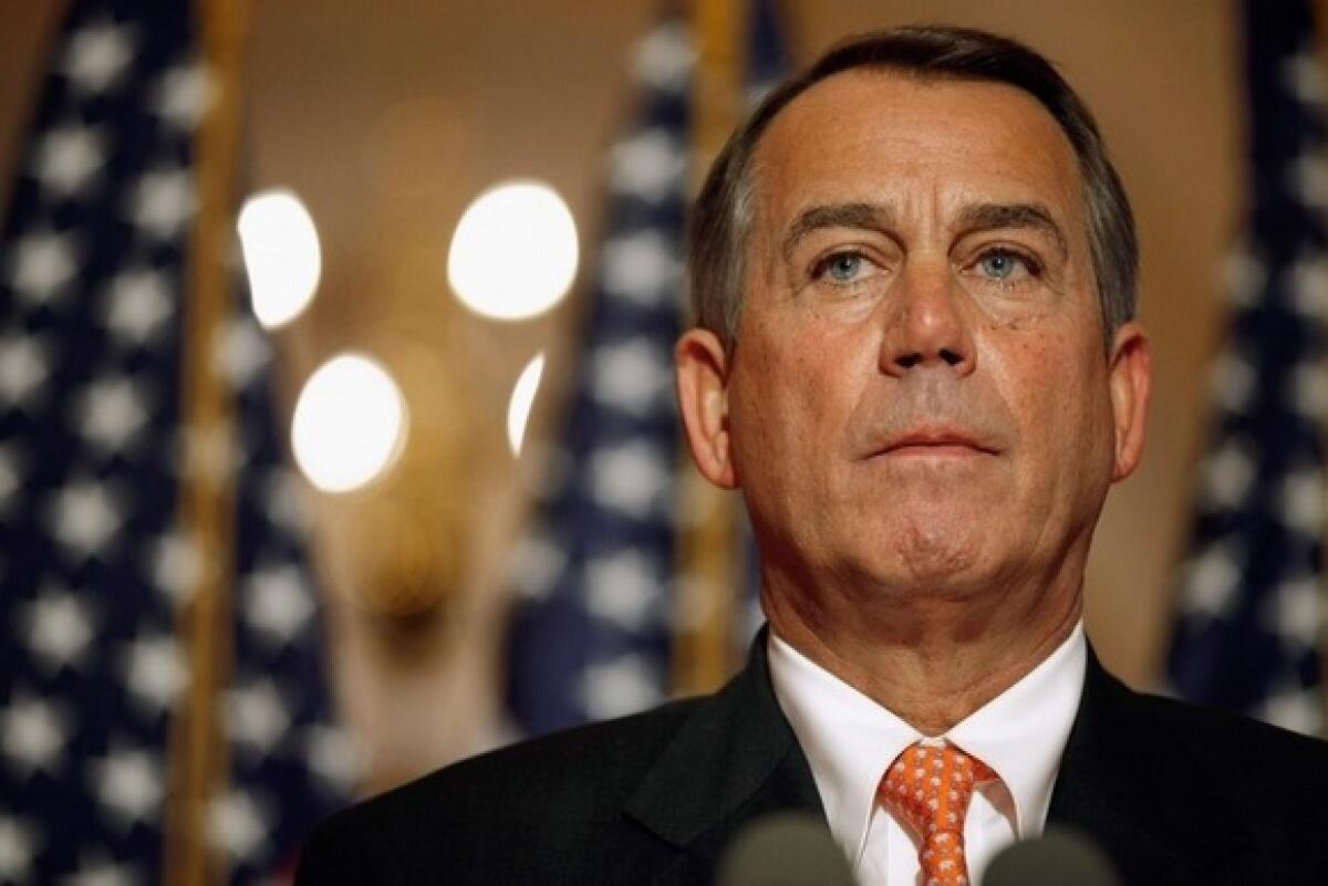 Speaker of the House John Boehner answers reporters' questions during a news conference on the payroll tax vote outside his office at the Capitol.