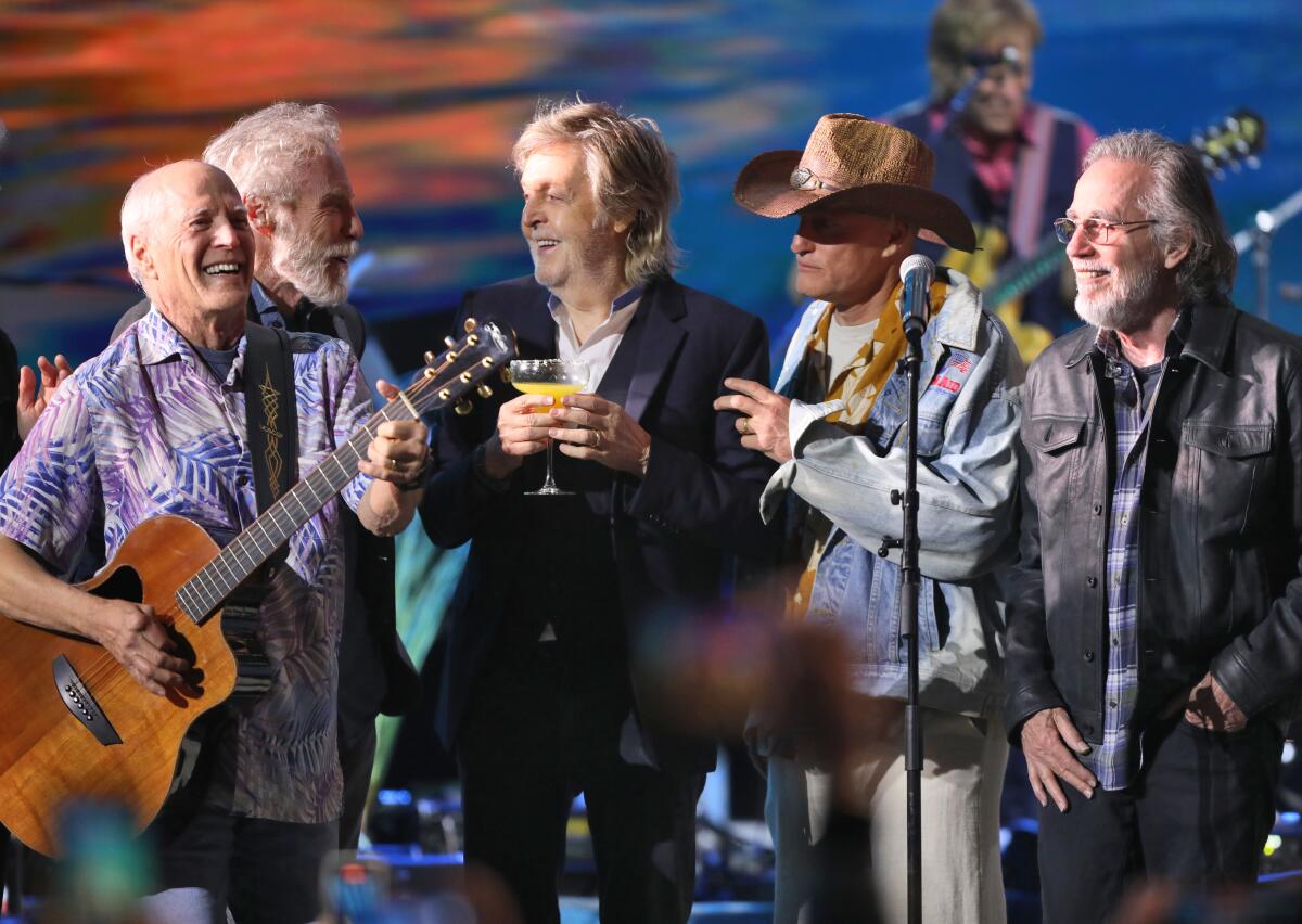 Paul McCartney, center, Woody Harrelson, Jackson Browne and members of the Coral Reefer Band pay tribute to Jimmy Buffett 