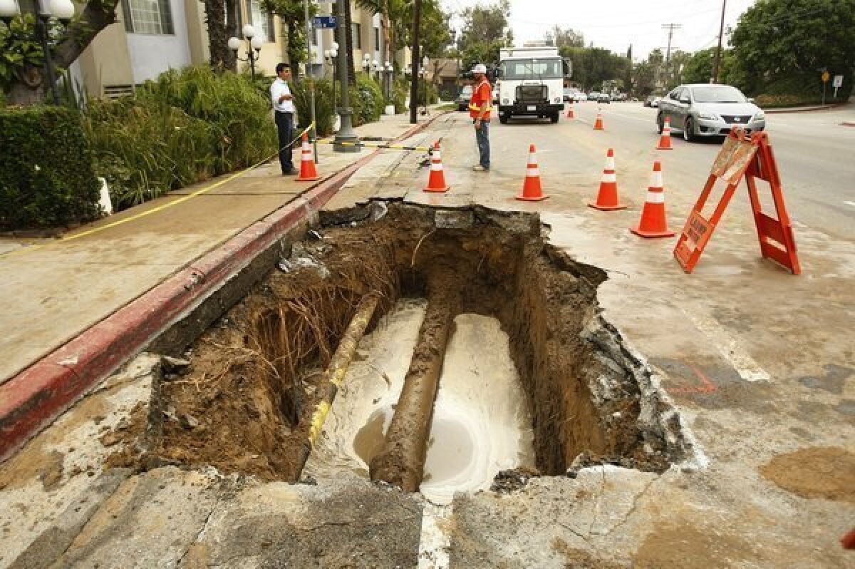 A hole on Cahuenga Boulevard in Hollywood exposes a 12-inch cast iron water main break. The pipe was installed in 1931.
