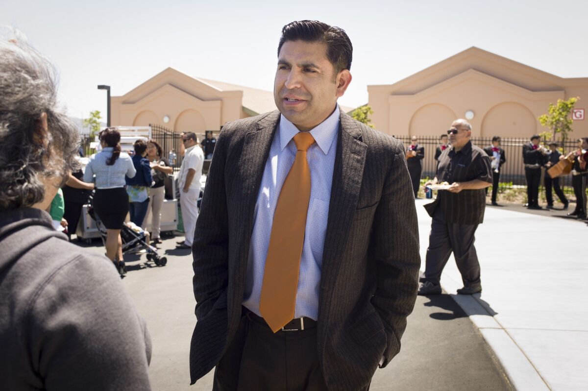 Salinas City Councilman and school board member Jose Castaneda greets people attending the dedication of the elementary school named for Tiburcio Vasquez. His support for the naming has come under fire.