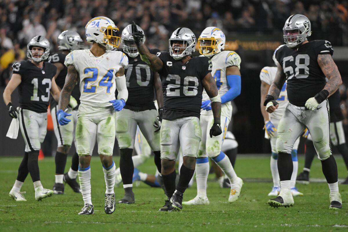 Las Vegas Raiders running back Josh Jacobs (28) celebrates after a play against the Los Angeles Chargers during overtime of an NFL football game, Sunday, Jan. 9, 2022, in Las Vegas. (AP Photo/David Becker)