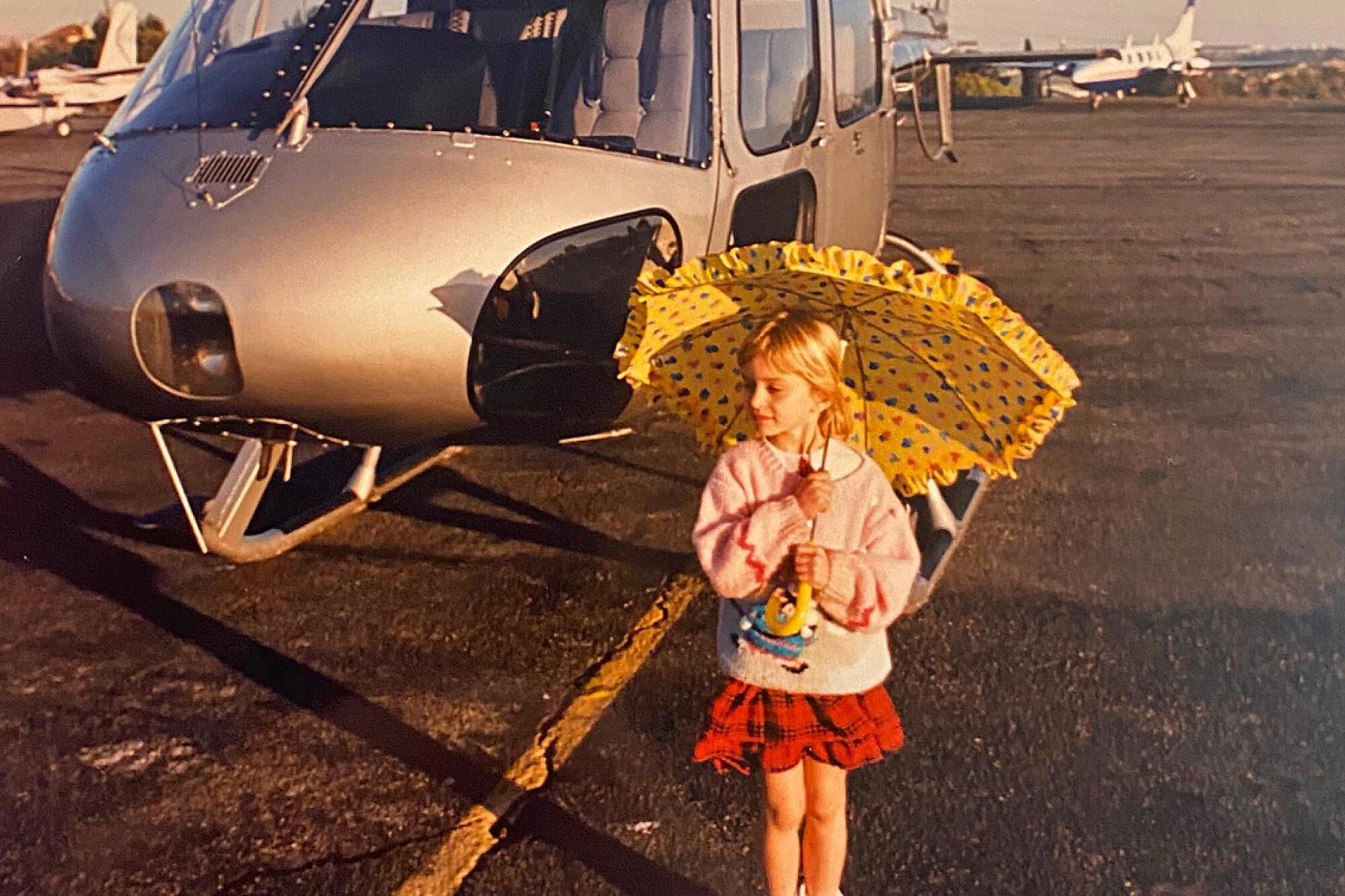 Katy Tur posing for her dad in front of the family helicopter.
