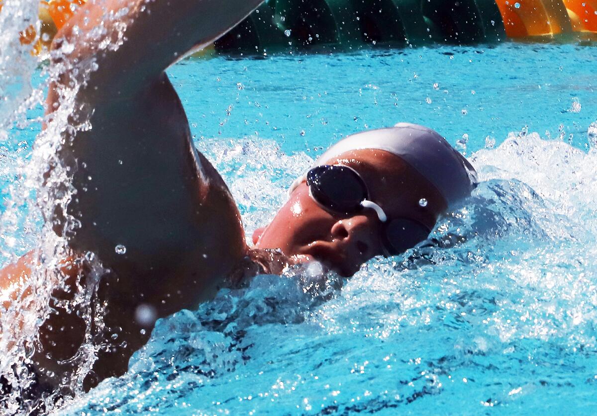 Newport Harbor's Harper Price competes in the 200-yard freestyle during the Surf League swim finals at Golden West College.