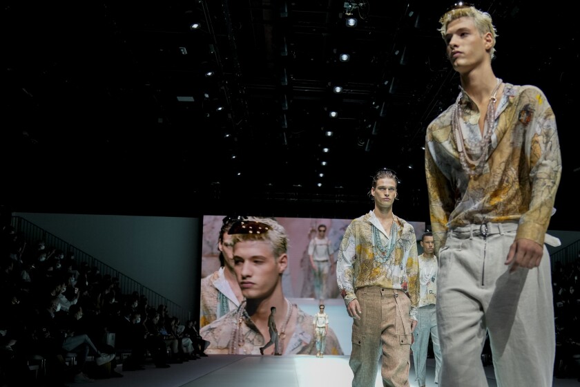 FILE - Models wear creations for the Emporio Armani Spring Summer 2022 collection during Milan Fashion Week, in Milan, Italy, Thursday, Sept. 23, 2021. Milan menswear previews for fall/winter 2021-22 are returning to a mostly in-person format in January, with Zegna, Giorgio Armani, Fendi and Prada among the 22 brands staging live runway shows, Milan’s fashion council announced Monday, Dec. 13, 2021. (AP Photo/Luca Bruno, File)