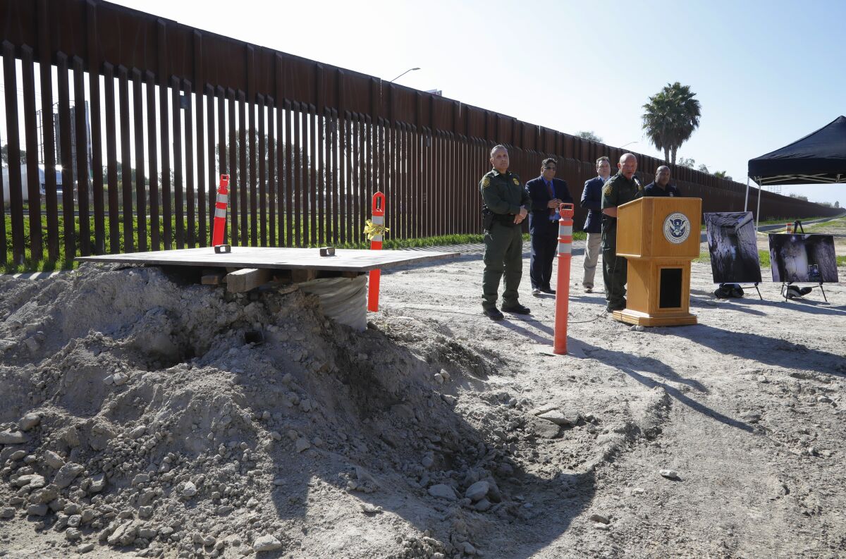 Standing next to an access point created by U.S. authorities on the U.S. side of the border, Deputy Chief Border Patrol Agent Aaron Heitke, right, and Special Operations Supervisor Cesar Sotelo held a news conference about the discovery of the longest border tunnel ever discovered.