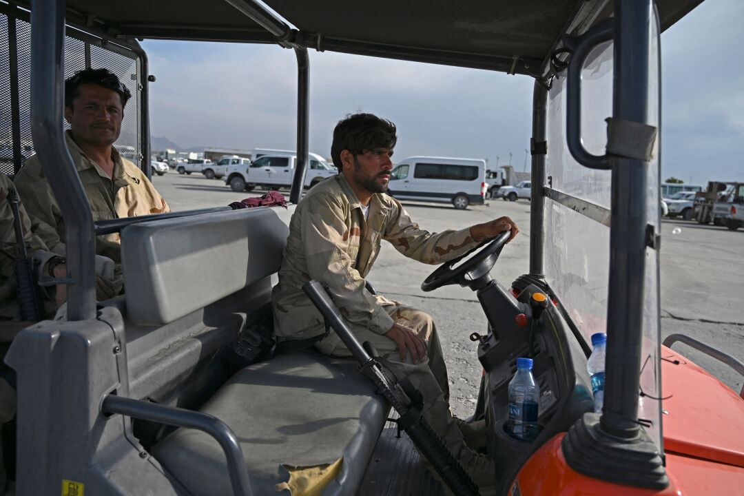 Afghan soldiers sit in a vehicle. 