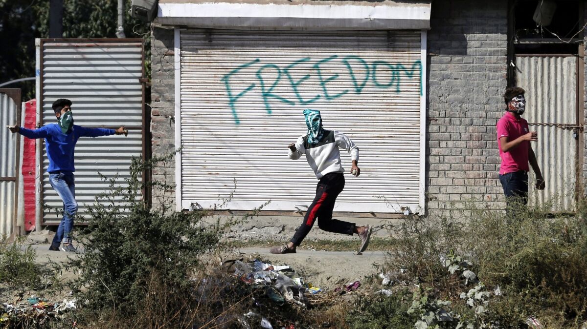 Kashmiri Muslims protesters throw stones at police and Indian paramilitary soldiers during a protest after Friday prayers in Srinagar, the summer capital of Indian Kashmir.
