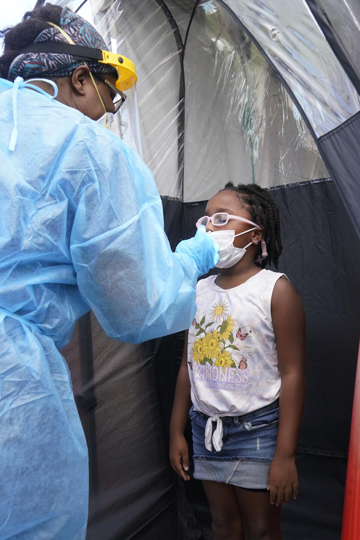 Juliani Pierre, 7, is tested for COVID-19, Tuesday, Aug. 31, 2021, in North Miami, Fla. Florida schools are seeing a rise in COVID-19 cases forcing teachers and students to quarantine. (AP Photo/Marta Lavandier)
