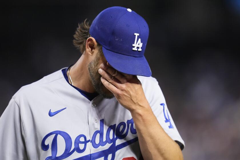 Los Angeles Dodgers starting pitcher Clayton Kershaw walks off the field at the end of the sixth inning.