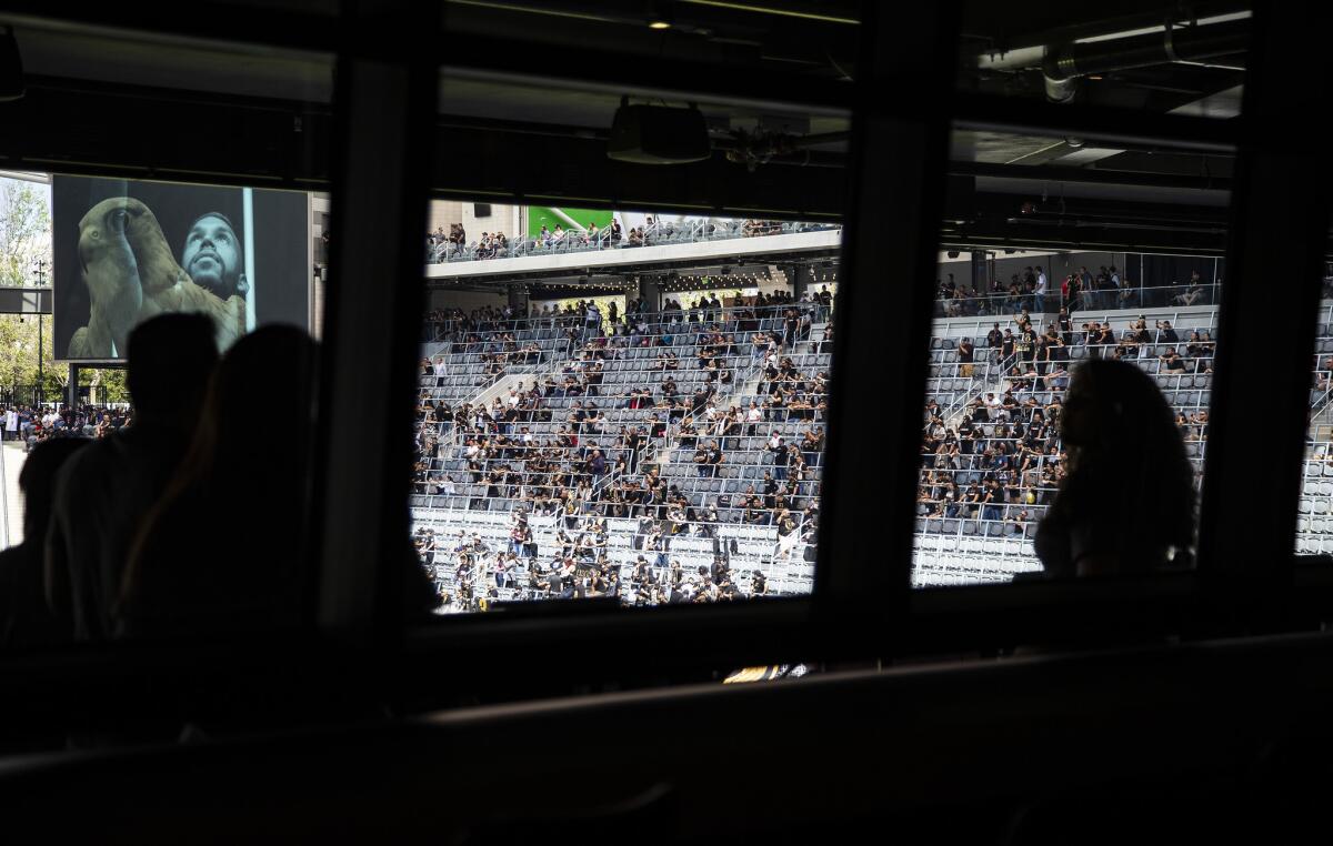 Soccer fans watch a halftime show from the deck outside the Figueroa Club at the new Banc of California Stadium.