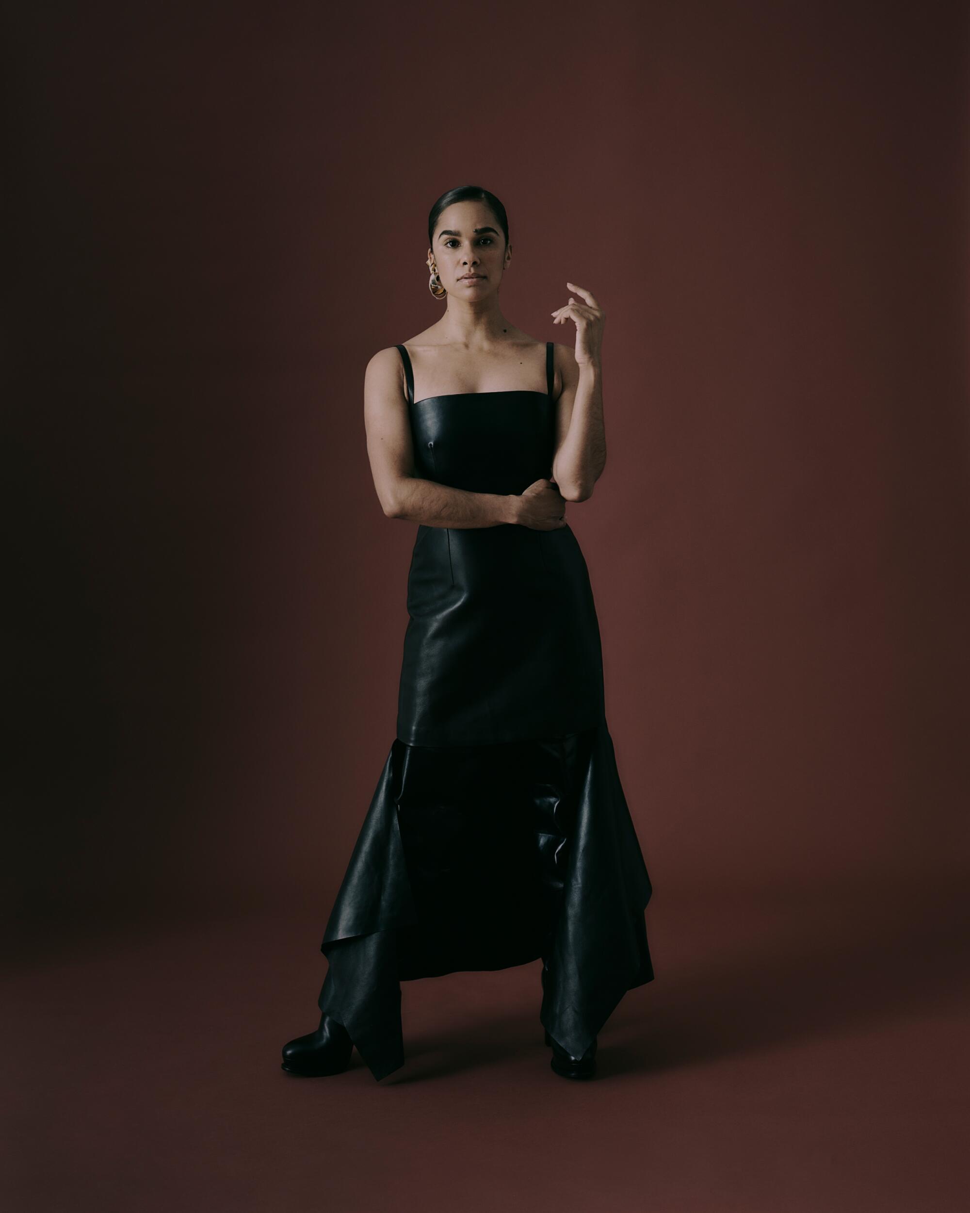Misty Copeland wearing a black dress and black shoes.