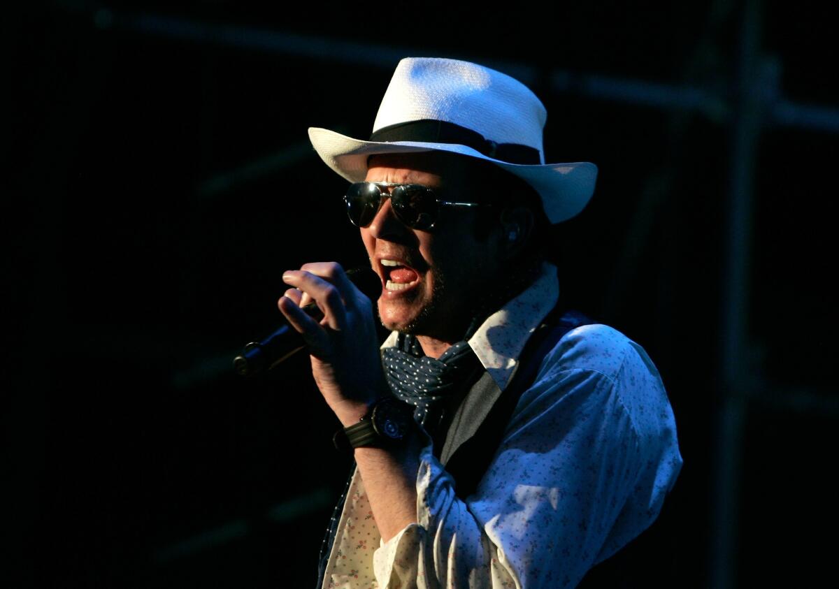 Singer Scott Weiland, shown performing in New York in July, says, "No one's ever fired anybody" from the Stone Temple Pilots, which recently announced it had "terminated" Weiland.