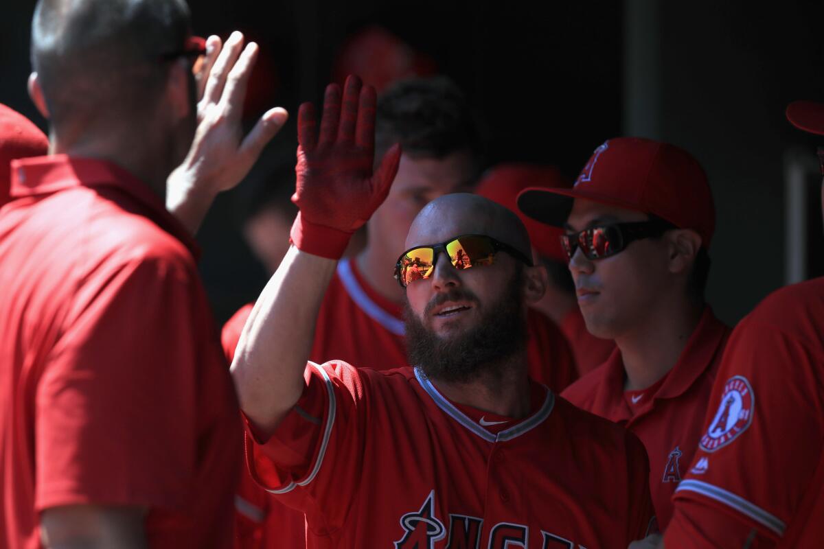 Angels outfielder Shane Robinson celebrates after scoring a run against the Rangers during the third inning of a game on May 1.