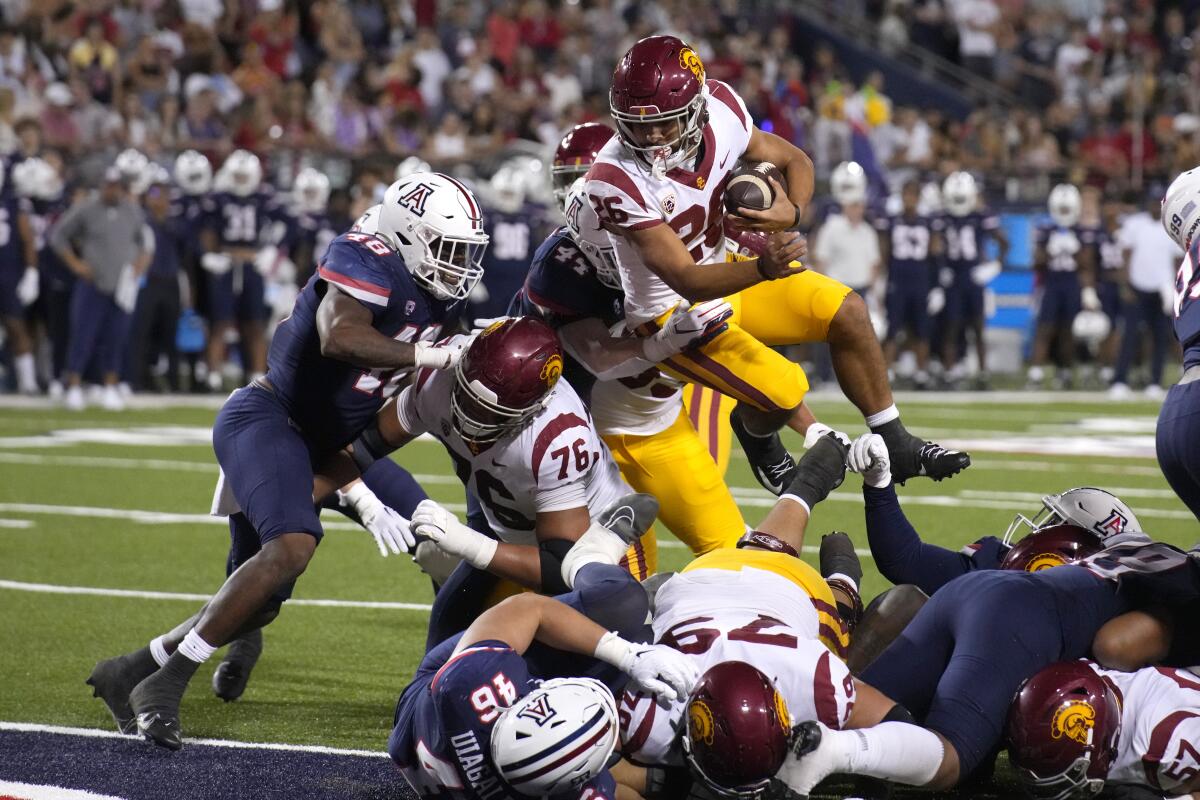 USC running back Travis Dye leaps over linemen to score a touchdown during the second half Saturday.