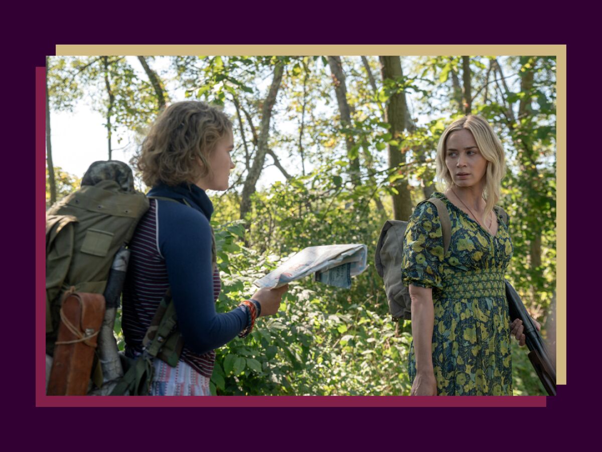Millicent Simmonds and Emily Blunt in the woods in a scene from "A Quiet Place Part II."