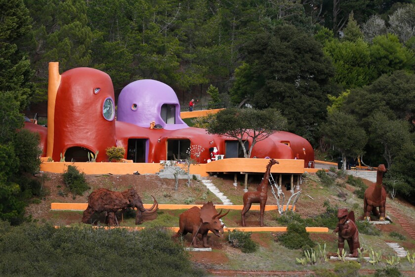 Statues of animals stand outside A menagerie of animals now stands guard at the famous Flintstone House.
