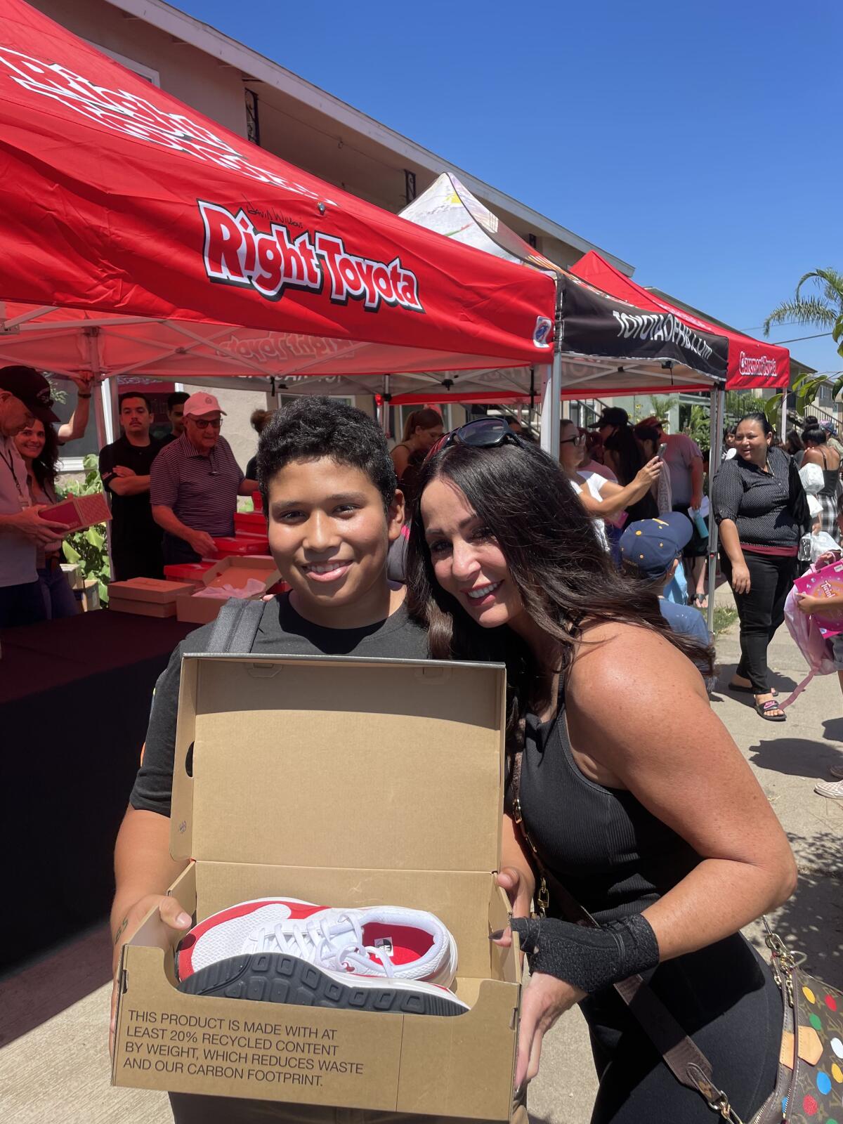 Jane D'Amelio of Wilson Automotive Group, right, poses with a happy teenager at Friday's event.