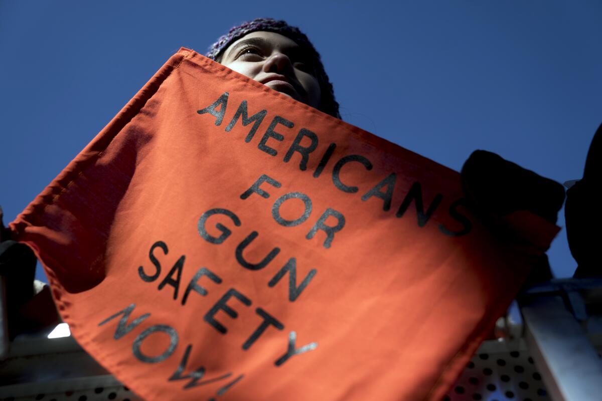  Isabel White of Parkland, Fla., holds a sign that reads "Americans for Gun Safety Now!" 