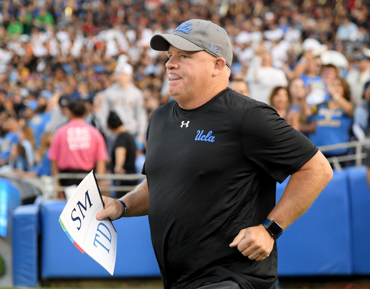 UCLA coach Chip Kelly runs on to the field before the game against Oregon State on Oct. 5 at the Rose Bowl.