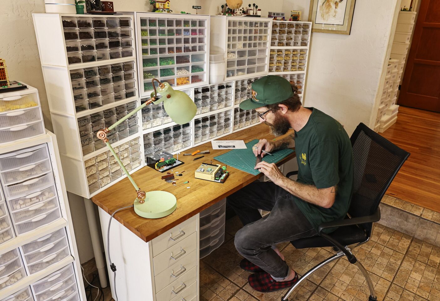 Lego artist Ben Smith works on his recreation of a North Park restaurant called Cori Trattoria Pastificio at his North Park home on Wednesday, July 20, 2022.