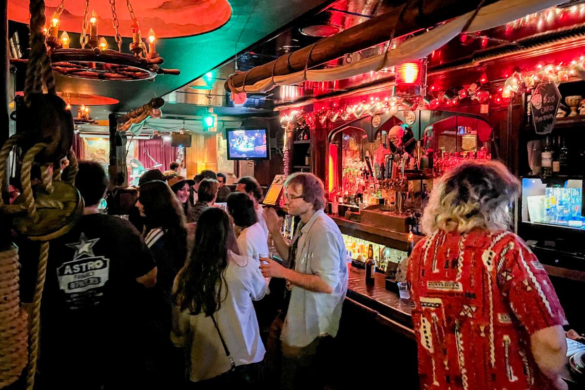 Inside the Redwood Bar and Grill with people at a bar.