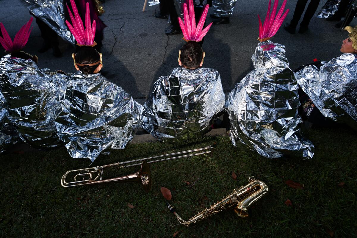 Band members wrap in Mylar blankets before the Rose Parade.