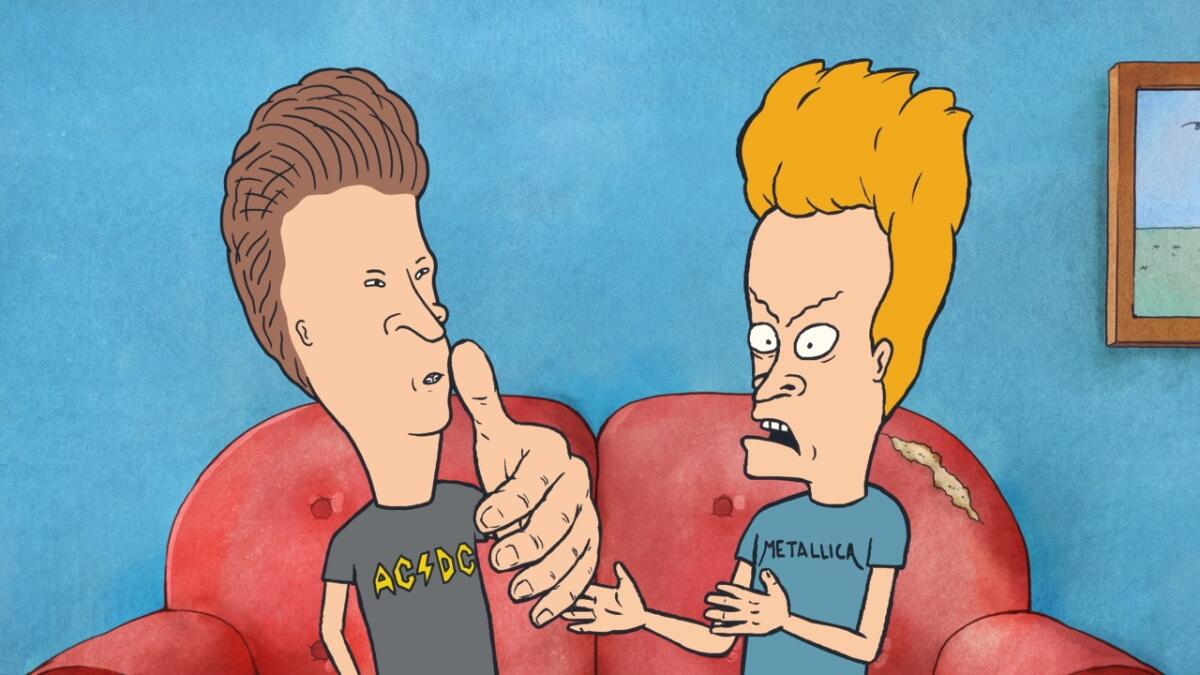 Two animated boys sit arguing on a couch