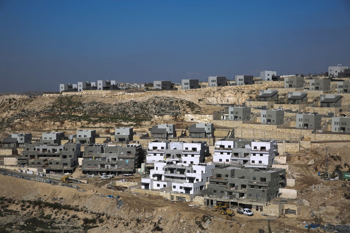 FILE - This Tuesday, Jan. 1, 2019, file photo, shows a new housing project in the West Bank settlement of Naale. Peter Beinart, an influential American commentator, has shocked the Jewish establishment and Washington policy-making circles by breaking a long-standing taboo: He has endorsed the idea of a democratic entity of Jews and Palestinians living with equal rights between the Jordan River and the Mediterranean. (AP Photo/Ariel Schalit, File)