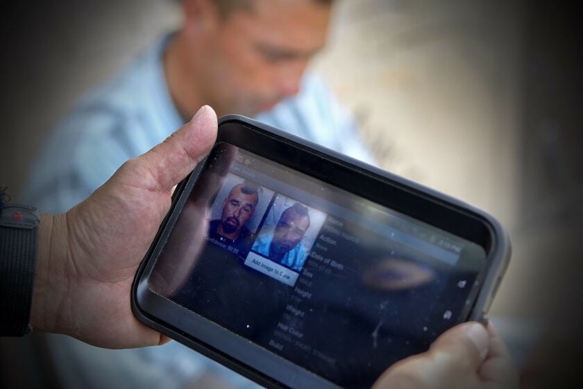 Chula Vista police Officer Roman Granados uses a computer tablet equipped with facial recognition software to compare a photo of a person he took while on patrol with photos in a database. Once possible matches are found, Granados compares the photos to make the final determination on a match, and learn, or confirm that person's identity.