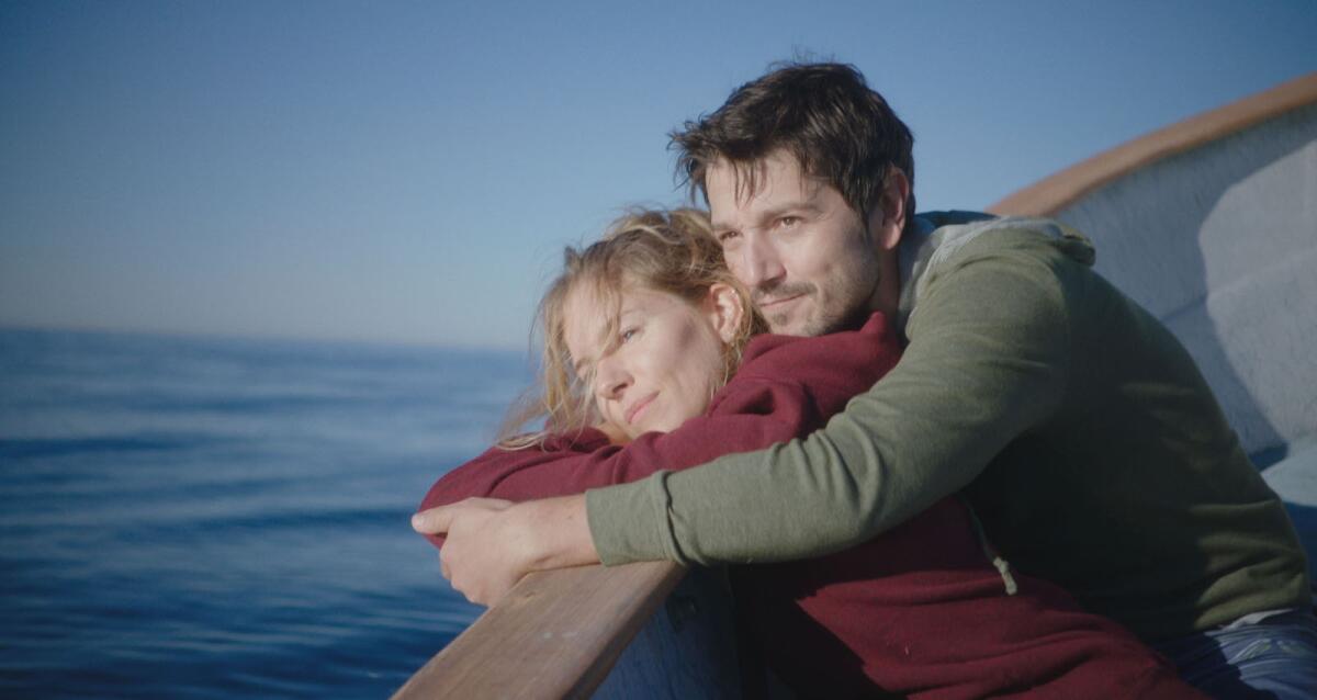 Sienna Miller and Diego Luna on a boat in the movie "Wander Darkly."