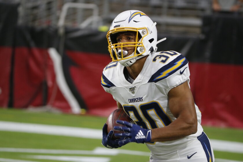 Chargers running back Austin Ekeler carries the ball during a game against the Arizona Cardinals on Aug. 8.
