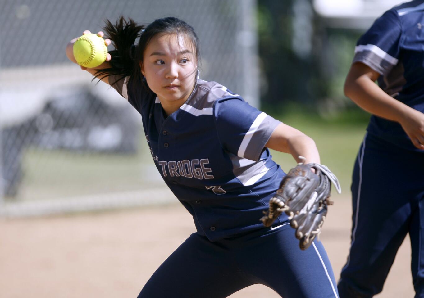 Flintridge Prep's softball pitcher #3 Therese Oshiro throws the runner out at first base in away game vs. Pasadena Poly in Pasadena on Wednesday, April 12, 2017.
