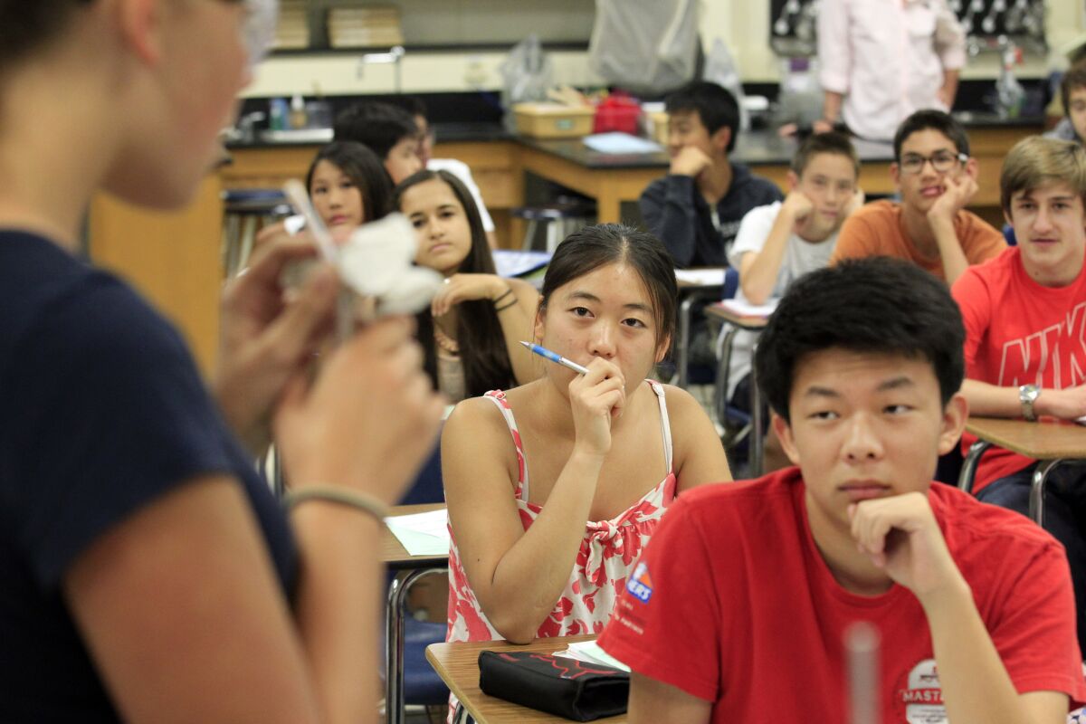 The American Acaedemy of Pediatrics recommends later start times for high schools and middle schools to combat chronic sleepiness in adolescents. Pictured here, Palos Verdes Peninsula High School students listen to a biology teacher in summer school.