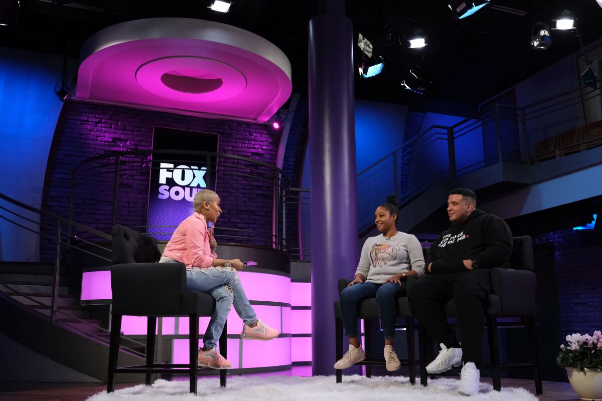 Keyshia Cole interviews Tiffany Haddish and Jason Lee on the set of her show for the streaming service Fox Soul.