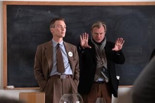 L to R: Cillian Murphy (as J. Robert Oppenheimer) and writer, director, and producer Christopher Nolan on the set of OPPENHEIMER.