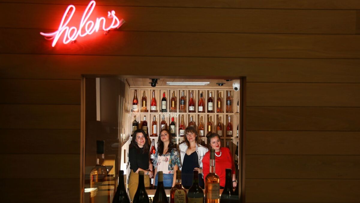 Helen Johannesen, third from left, in her wine shop, Helen's Wines, which sits in the middle of Jon and Vinny's restaurant. Johannesen's employees are Molly Kelly, left, Bethany Kocak and at far right, Heather Newman.