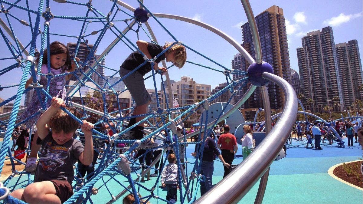 Children play on the playground equipment adjacent to the County of San Diego Waterfront Park at the County Administration Building.