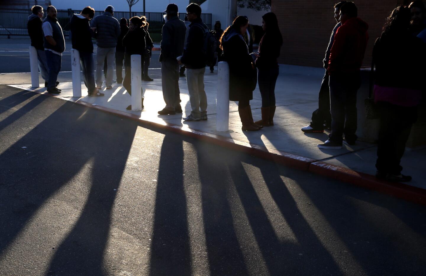 People stand in the cold at the Santa Ana DMV office.