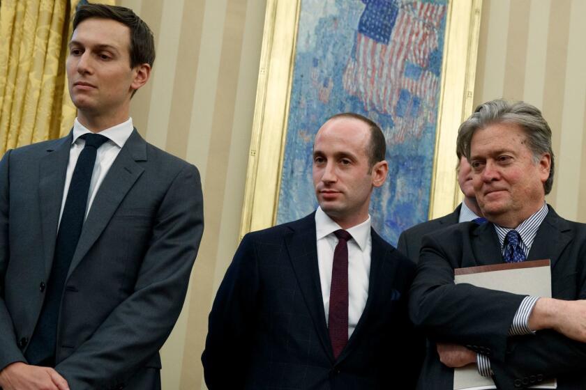 Jared Kushner, Stephen Miller and Stephen Bannon stand together in the Oval Office of the White House last month.