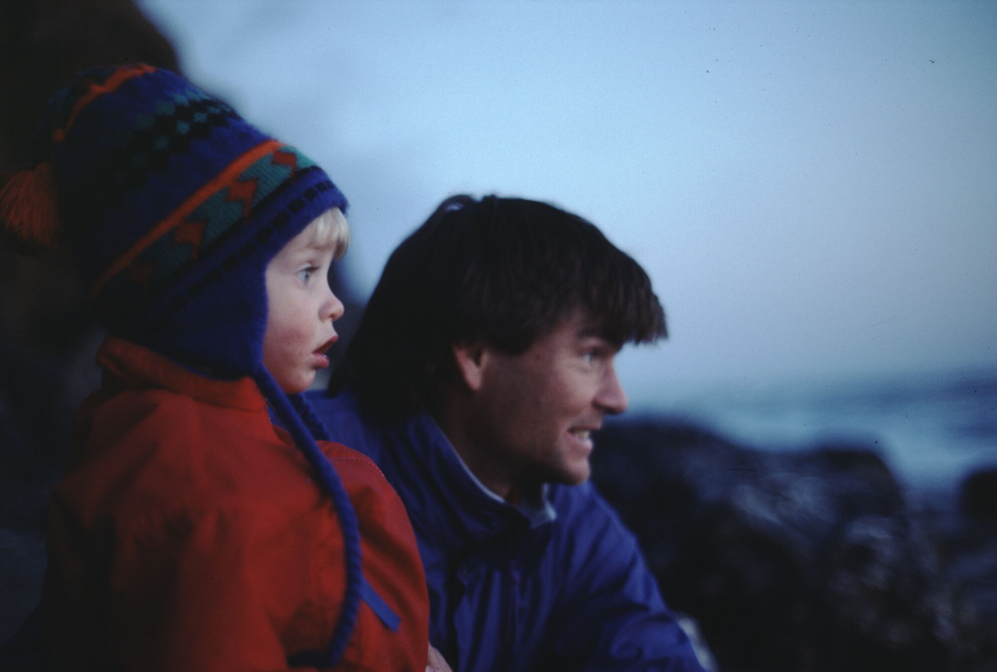 A man and a young boy in outdoor cold-weather gear.