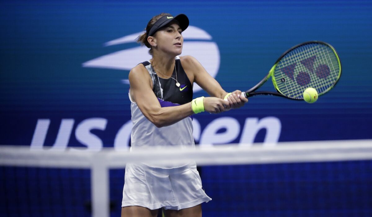 Belinda Bencic returns to Naomi Osaka during their fourth-round match at the U.S. Open on Monday.