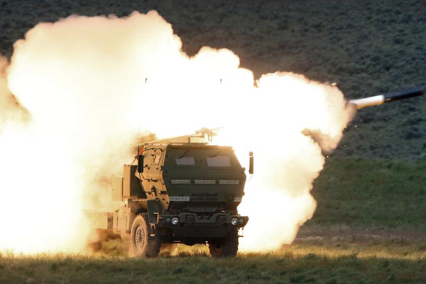 FILE - A launch truck fires the High Mobility Artillery Rocket System (HIMARS) produced by Lockheed Martin during combat training in the high desert of the Yakima Training Center, Washington in May 23, 2011. The HIMARS systems supplied by the U.S. and similar M270 provided by Britain have significantly bolstered the Ukrainian army's precision strike capability. The deliveries of Western arms have been crucial for Ukraine’s efforts to fend off Russian attacks in the nearly 5-month-old war. (Tony Overman/The Olympian via AP, File)