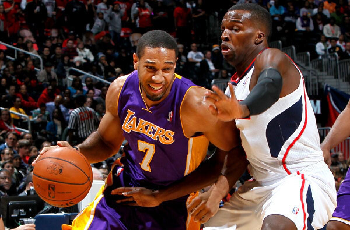 Lakers swingman Xavier Henry drives against Hawks guard Shelvin Mack.